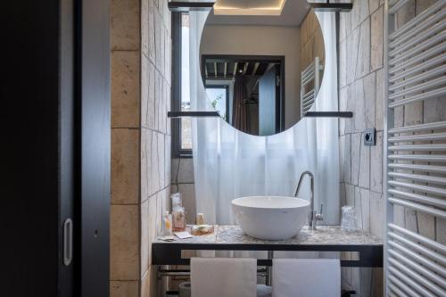 a bathroom with a sink and a mirror at Suite Orcio in San Gimignano
