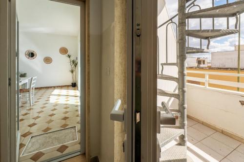 a door leading to a room with a balcony at Blue Bay Lux House in Torre Lapillo