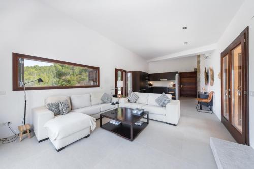 a living room with a white couch and a table at Dream Property in Alconasser in Sóller