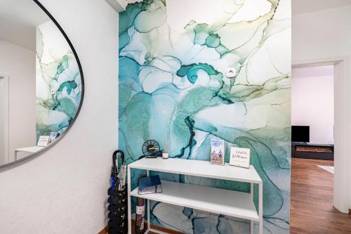 a bathroom with a mirror and a sink at Ferienwohnung Krause Dachgeschoss in Wilhelmshaven