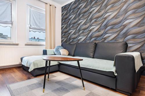 a living room with a couch and a table at Ferienwohnung Krause Dachgeschoss in Wilhelmshaven