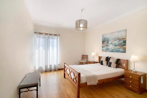 a bedroom with a large bed and a window at Vilamoura Marina in Vilamoura