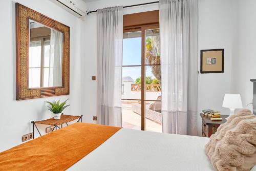 a bedroom with a bed and a window with a view at Costa Luxe Almuñecar in Almuñécar