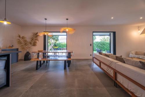a living room with a table and a couch at Villa bord de mer avec piscine in Hyères