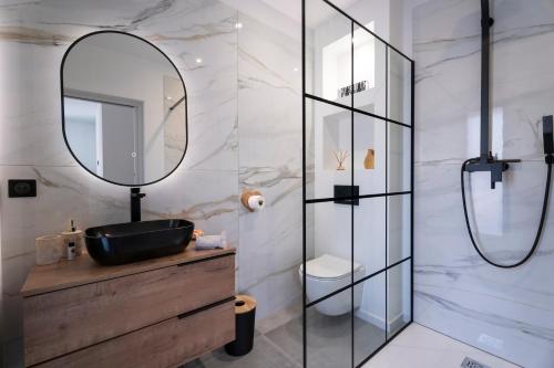 a bathroom with a sink and a mirror at Villa bord de mer avec piscine in Hyères