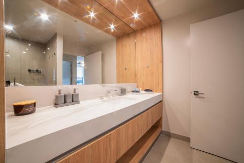a bathroom with two sinks and a large mirror at Crosby Miami World Center in Miami