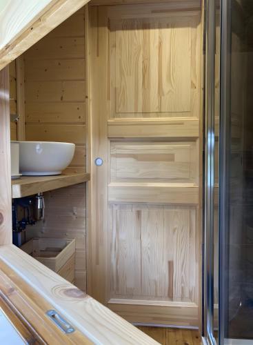 a small kitchen with wooden cabinets and a sink at Le Kota Du Paradou in Givet