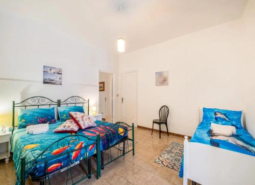 a bedroom with a bed and a desk and a chair at Villa Tramonto Ionico Torre Lapillo in Torre Lapillo