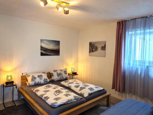 a bedroom with a bed and a window at Schiller´s Urban Escape in Freudenstadt