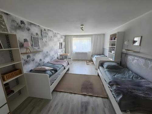 a small room with two beds and a couch at Regenhäusl Waldbach in Arrach