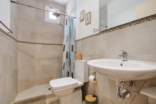 a bathroom with a sink and a toilet at El Cotillo Mar Sea View in El Cotillo