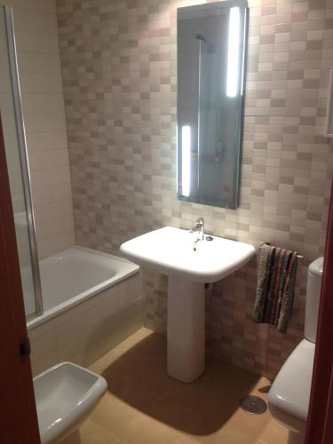 a bathroom with a sink and a tub and a toilet at La Azohía Espacio en Calma in La Azohía