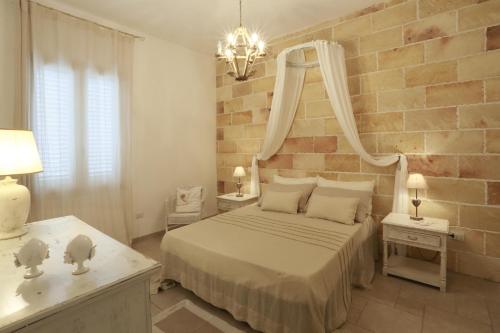 a bedroom with a bed with a mirror on the wall at Villa Dina in Nardò