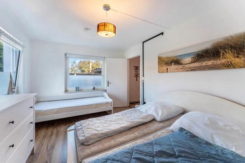 a bedroom with two beds and a window at Insel Koje 1-1 in Fehmarn