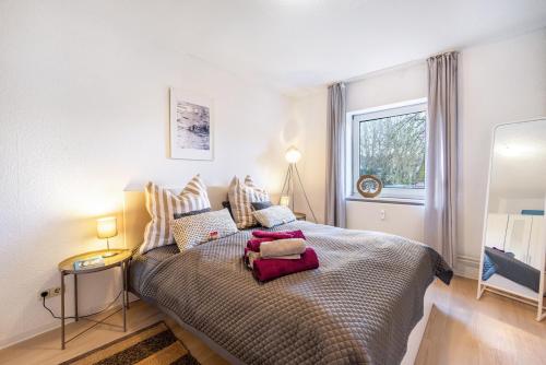 a bedroom with a bed with pillows on it at Wohnung Horsti in Timmendorfer Strand
