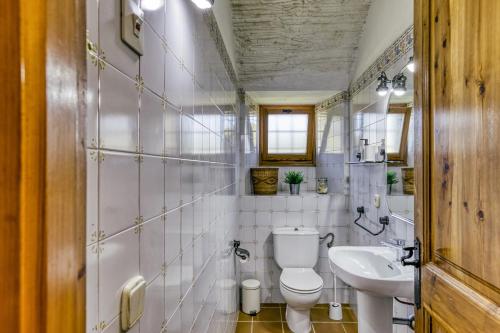 a bathroom with a toilet and a sink at Mas Cases in Girona