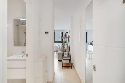 a bathroom with white cabinets and a ladder at Apartamento Blue Wave 1 10 in Tarifa
