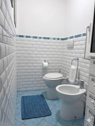 a white bathroom with a toilet and a sink at Casa di Mà Varazze in Varazze