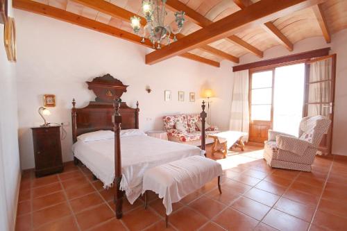 a bedroom with a bed and a table and chairs at S'hort des Cura in Islas Baleares