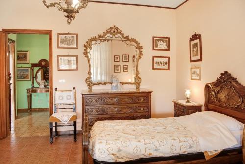 a bedroom with a bed and a large mirror at Magnolia in Cisterna dʼAsti