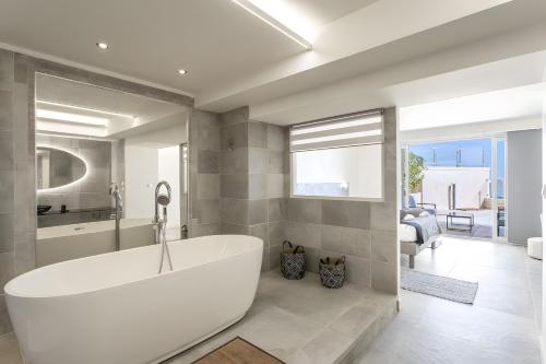 a bathroom with a large white tub in a room at Villa Baraka in Sainte-Maxime