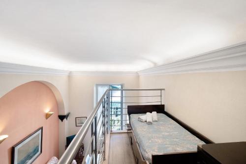 a room with a bed and a stair case at Buddha, borgo dei pescatori in Cervo