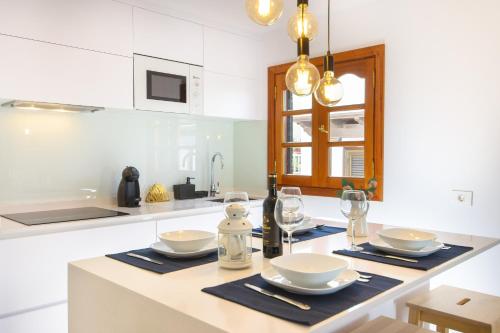 a kitchen with a table with plates and glasses at Vela in Arrecife