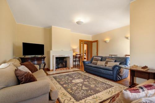 a living room with two couches and a fireplace at Dunas Das Marinhas in Marinhas