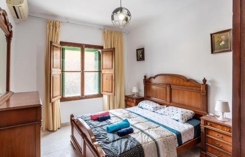 a bedroom with a bed and a dresser and a window at Cas Llimoner in Palma de Mallorca