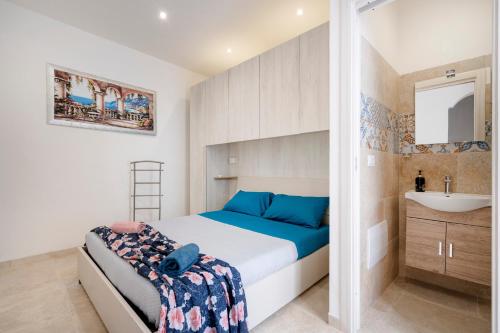 a small bedroom with a bed and a sink at Dimora Don Gabriele e Suite in Mola di Bari
