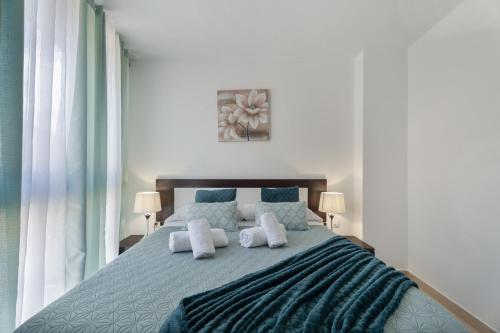 a bedroom with a blue bed with two pillows at Apartamento Estrella in Candelaria