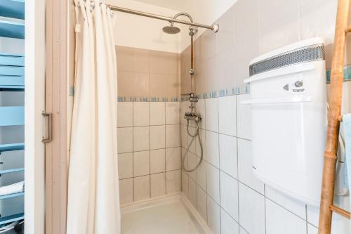 a bathroom with a shower with a shower curtain at Gîte du Badassier in Blauvac