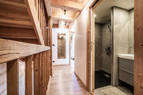 a bathroom with wooden walls and wooden flooring at Chalet Stéphane centre chatel in Châtel