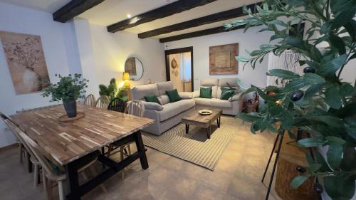 a living room with a couch and a table at Casa Rural El Olivo in Segovia