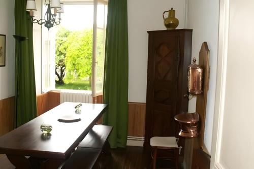 a dining room with a table and a window at Gites Du Château De Saveilles in Paizay-Naudouin