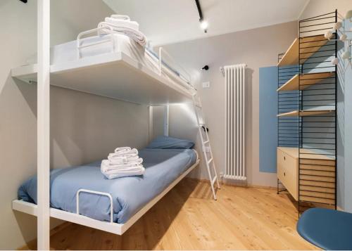 a bedroom with a bunk bed and a ladder at Palazzo Righi - App Blu in Carisolo