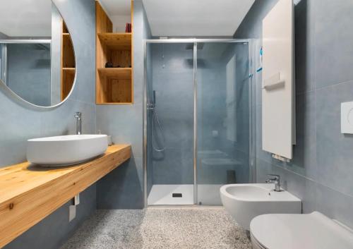 a bathroom with a sink and a shower at Palazzo Righi - App Blu in Carisolo