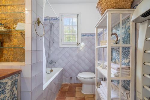 a bathroom with a toilet and a tub and a sink at Son Oliver in Palma de Mallorca