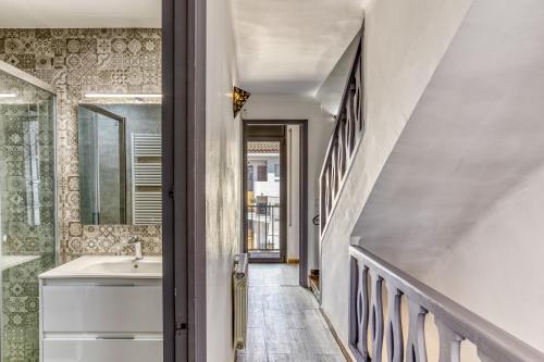 a bathroom with a sink and a staircase at Port Empúries in Empuriabrava