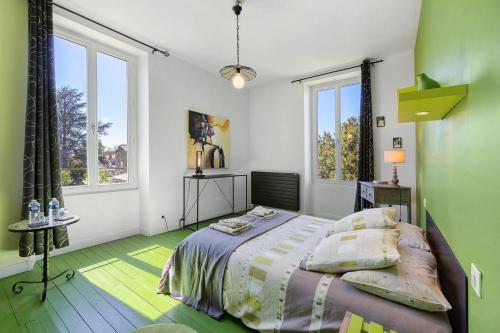 a bedroom with a bed and two windows at Chambres D'hôtes La Baritaudière in La Réorthe