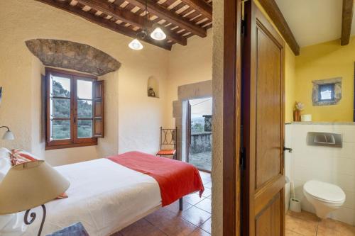 a bedroom with a bed and a bathroom at Mas Vinyoles in Centellas