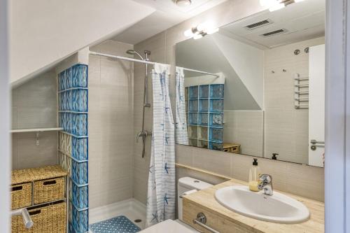 a bathroom with a sink and a shower at Roses Apartaments Luxury Duplex in Roses