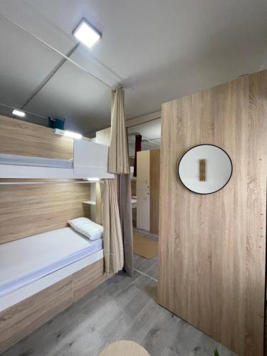 a room with two bunk beds and a mirror at Therma Pilgrim Hostel in Caldas de Reis
