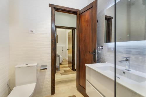 a bathroom with a sink and a toilet and a mirror at Casa Miranda 3 in Igueste