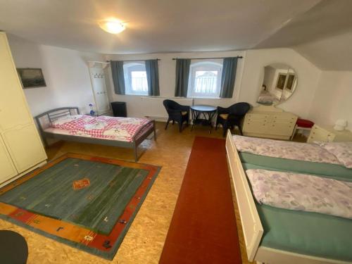 a room with two bunk beds and a table at Ferienhaus Winter in Blaibach
