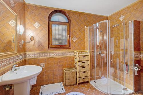 a bathroom with a sink and a shower at Roc Blau in Begur