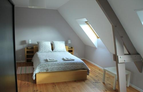 a bedroom with a bed in a attic at La Morinière in Vieux