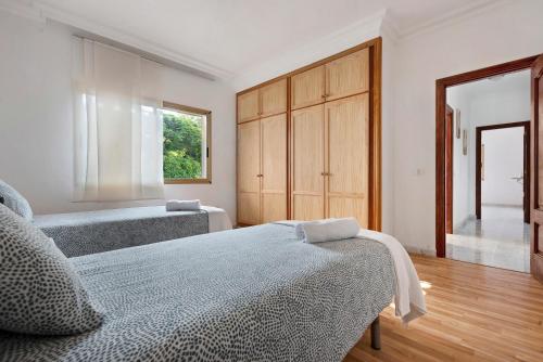 a bedroom with two beds and a large window at Jalón de Cameros in Tacoronte