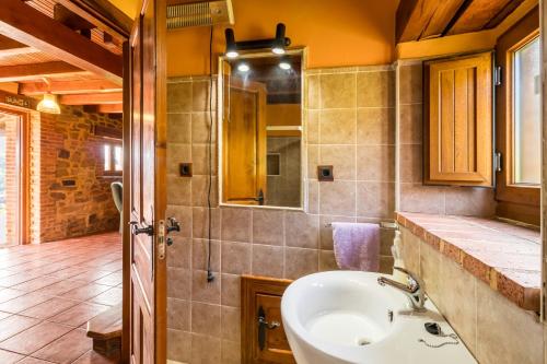 a bathroom with a sink and a mirror at Casa Alba in Bárcena de Cicero