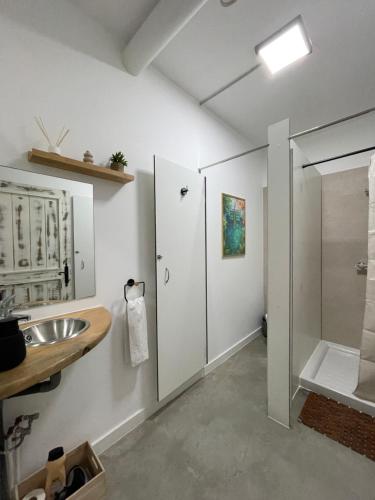 a bathroom with a shower and a sink at Therma Pilgrim Hostel in Caldas de Reis